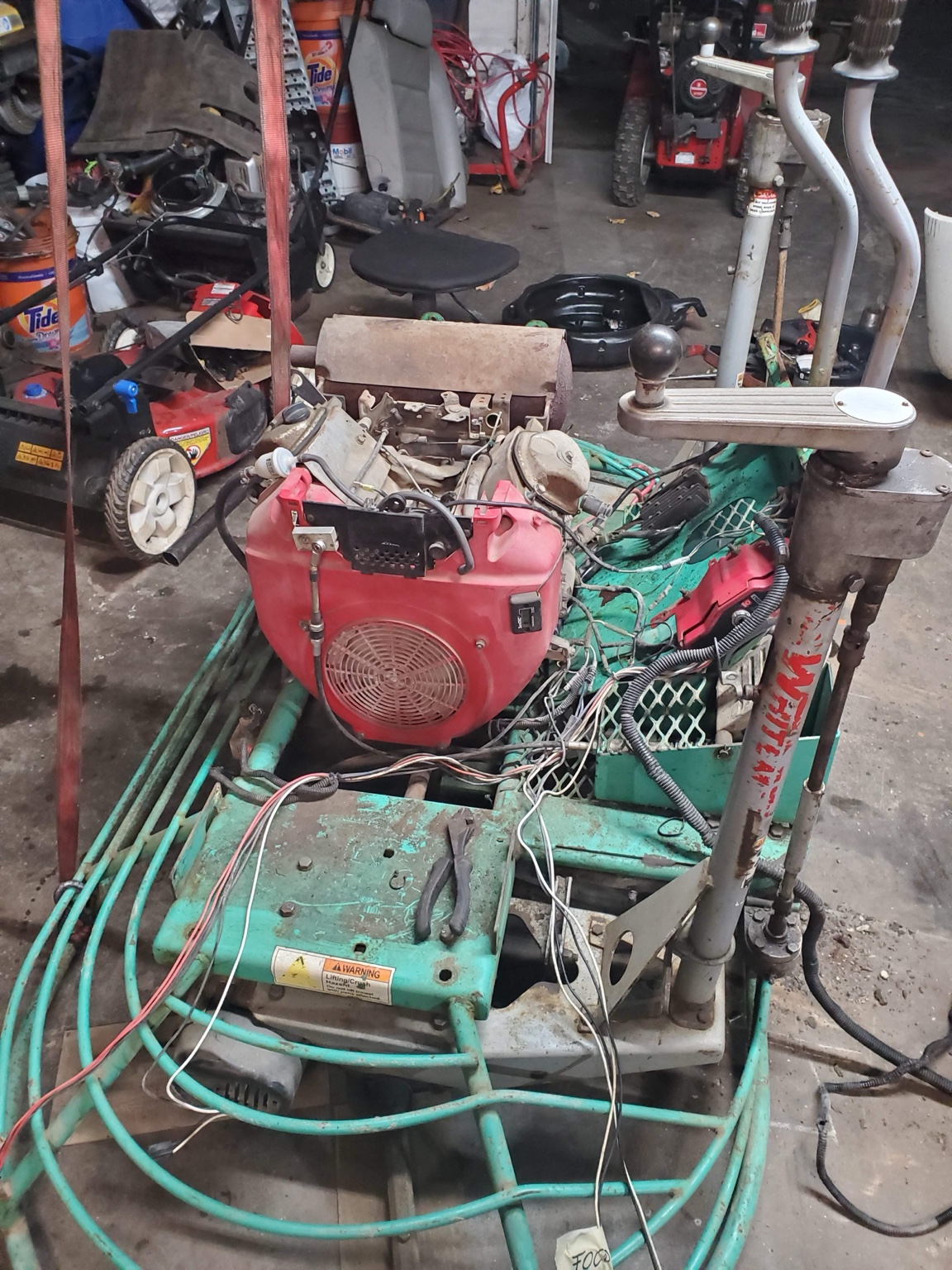 Ride-on power trowel under repair